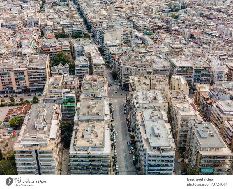 Thessaloniki, Greece aerial drone landscape view of Analipsi borough buildings rooftops. Day top panorama of European city with residential blocks of flats around road on a sunny day.