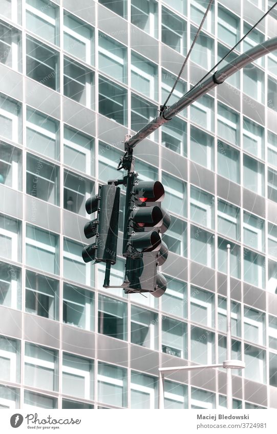 Traffic lights with a modern office building in background. traffic city signal stoplights transport safety no people lighting equipment traffic lights