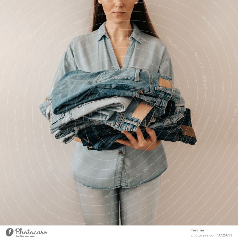 Denim care, jeans sale, recycling wear, fast fashion concept denim jeans care reuse denim care recycle garment care sustainable unrecognizable stack lot blue