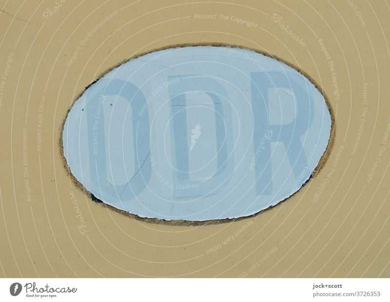 Number plate GDR Illustration Germany Oval Past Change Subdued colour Weathered Ravages of time Neutral Background Transience pasted over Translucent