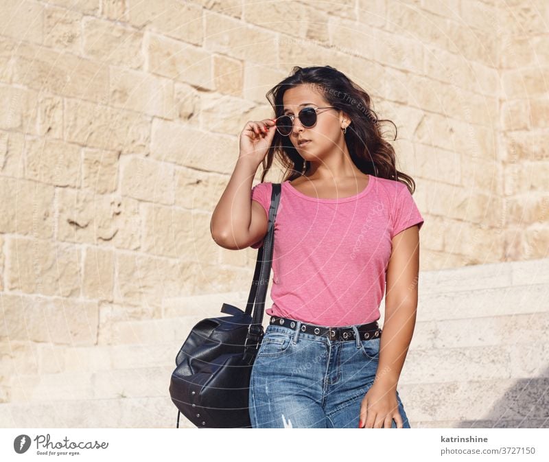 Young women going down the stairs and touch sunglasses girl wear mockup t-shirt jeans swatch round neck apparelmockup casual mock up longhair Person Outdoor