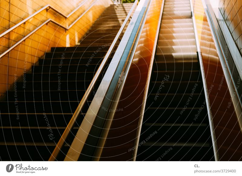 stairs and escalator Stairs Escalator Upward handrail Banister stagger sloth Architecture Subway station up and down urban Yellow Esthetic Deserted Colour photo