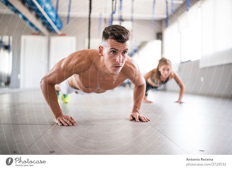Woman Push-ups On The Floor At The Gym Stock Photo, Picture and