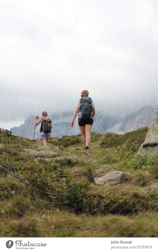 2 women hiking in the mountains Mountain Stony Woman two Backpacking Backpacking vacation Hiking cloudy sky Fog short pants Summer Summer vacation Exterior shot