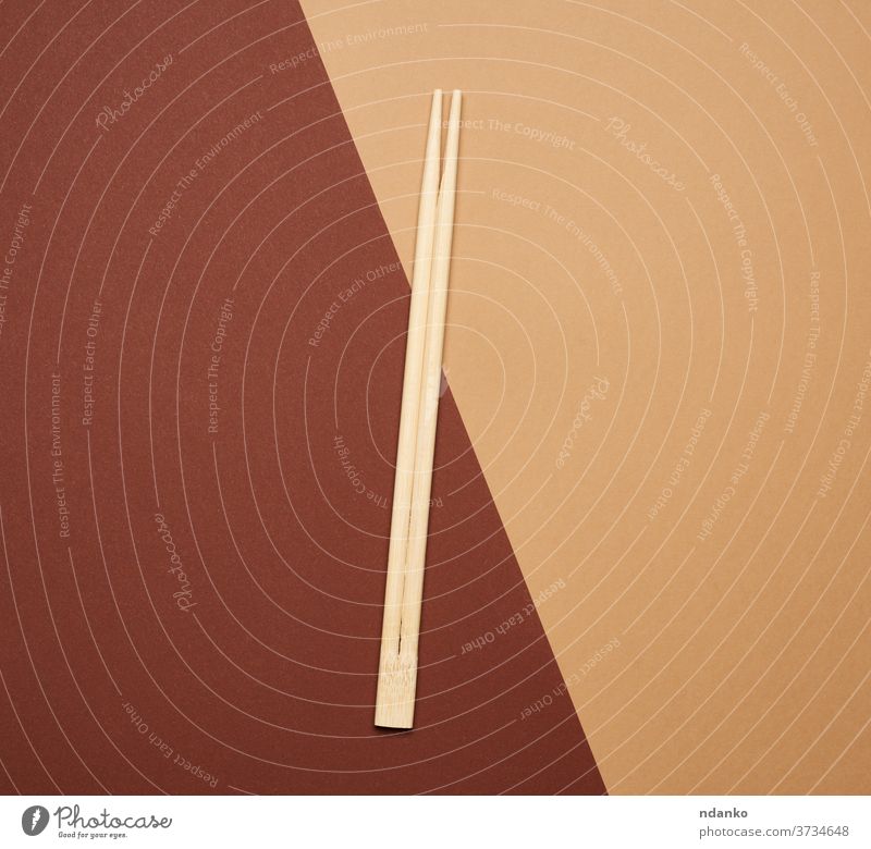pair of wooden chopsticks on a brown background tool traditional chinese asian utensil japanese two china cuisine closeup kitchen bamboo food simplicity sushi