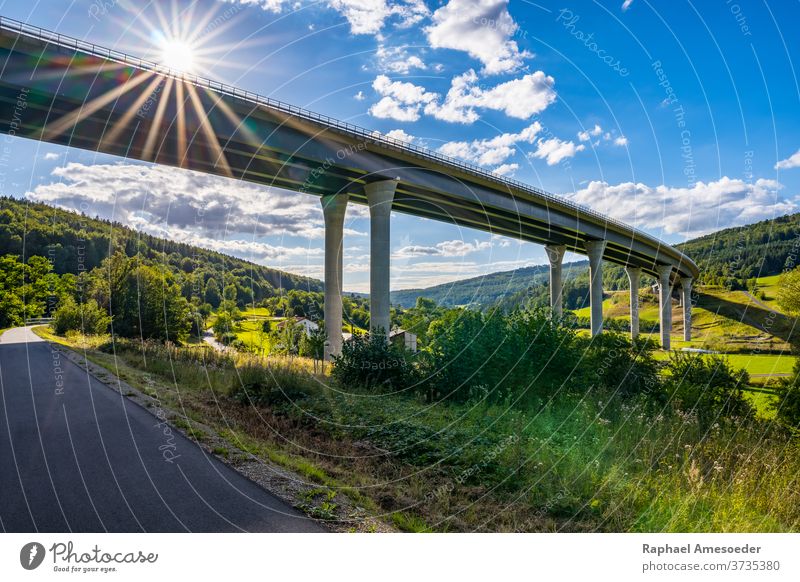 View of Sinntal Bridge from below on sunny summer day abutment arch architecture blue bridge building bush cement clouds concrete curve footpath forest freeway