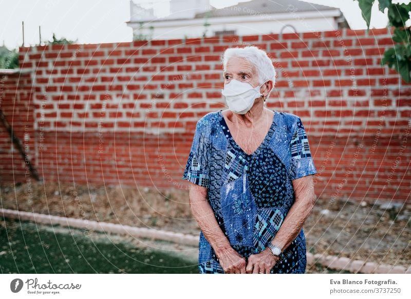 portrait of old lady wearing protective mask. new normal corona virus elder 80s grandmother woman elderly home white hair grey hair mental aged health care