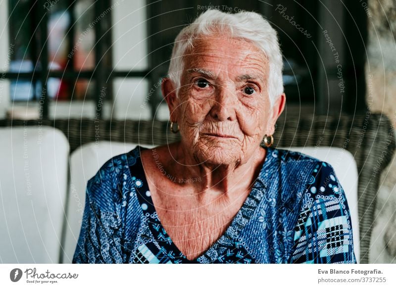 portrait of old lady in her 80s relaxed at home. woman elderly garrotte white hair grey hair mental solitude thoughtful grandmother aged health care looking