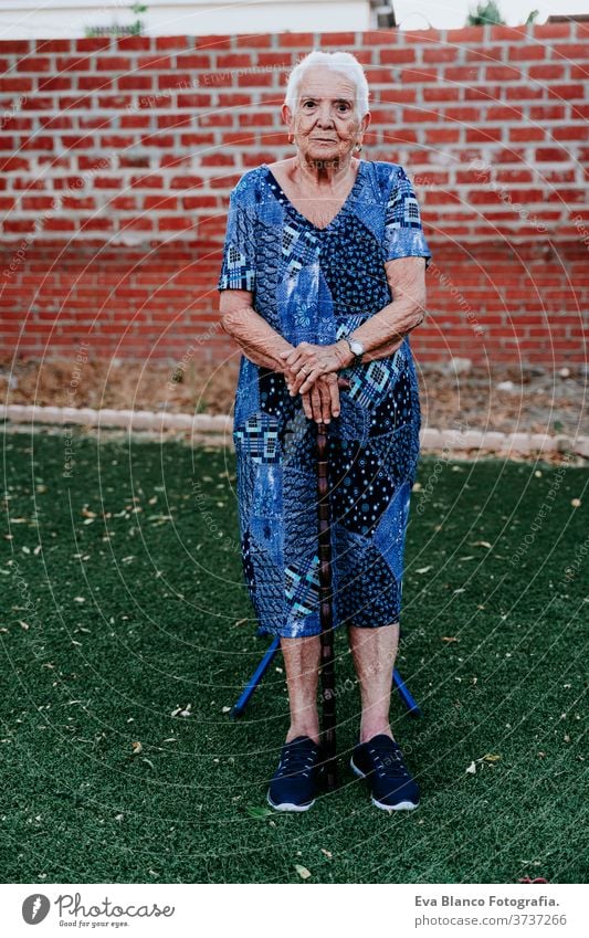 portrait of old lady in her 80s relaxed outdoors woman elderly home garrotte white hair grey hair mental solitude thoughtful grandmother aged health care