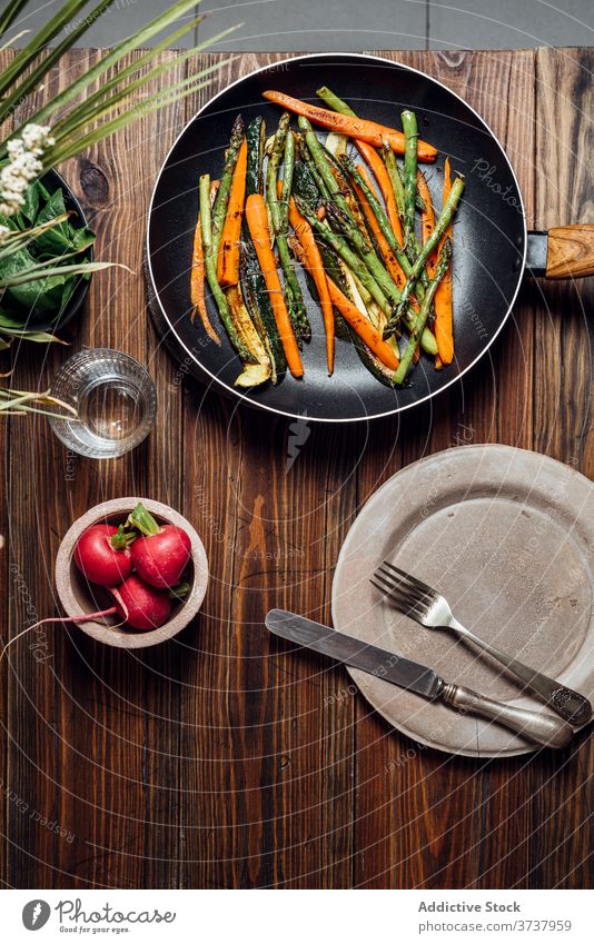 Carrot, asparagus and zucchini sauteed in the pan, on the table gourmet carrots concept modern mix new traditional background prepared recipe rustic vegetarian