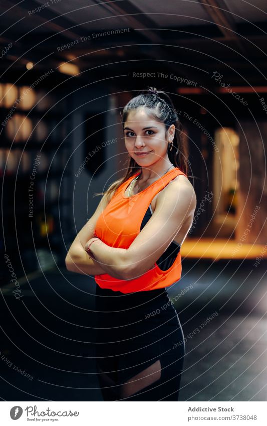 Confident fit woman standing in gym sporty confident determine serious muscular strong athlete sportswoman young female workout training power motivation