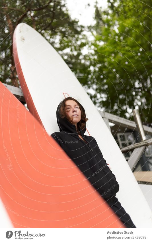 Sportswoman on shore with paddle board paddleboard relax surfer calm surfboard wooden embankment rest female surfing sport summer athlete activity tranquil