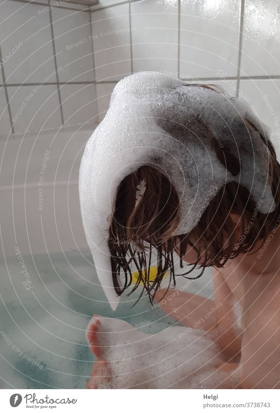 foam hairstyle - child sits in the bathtub and plays with the foam Child Bathtub Water Foam Hair washing Playing bathe Wash Hair and hairstyles Bathroom Wet