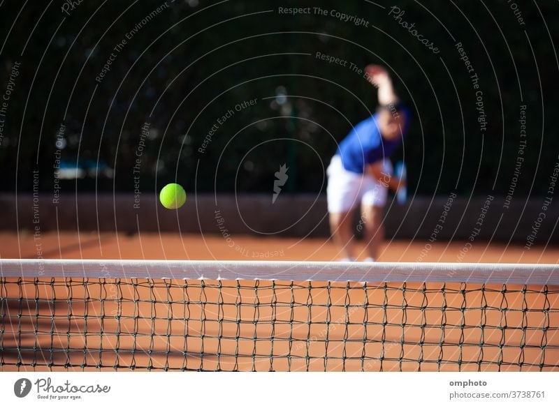 Tennis ball just over the net after powerful first serve of a player tennis court hitting shoot ace win game set competition point score sport racquet racket