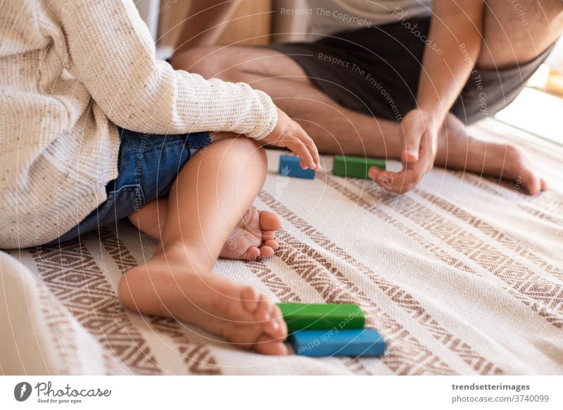 kid and his father playing at home with wood building blocks. Homeschooling. Stay at home. Family time covid-19 safe coronavirus stay at home quarantine family
