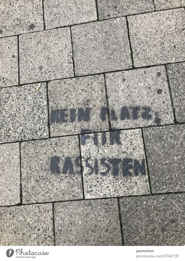 No room for racists on cobblestones on the floor. Embassy, streetart. anti-racism. Racism embassy resistance politically Attachment street art Characters