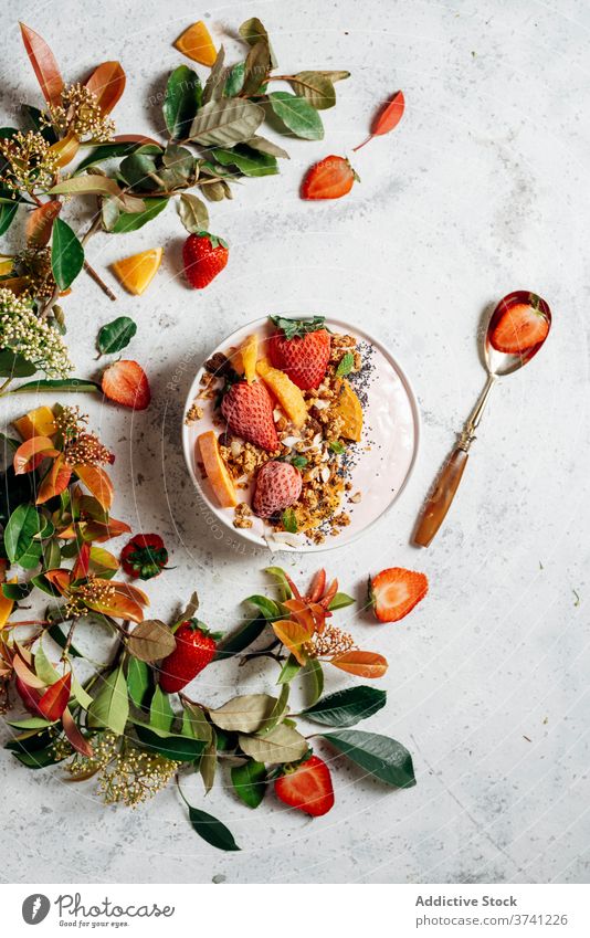 Healthy breakfast bowl with fruits on table smoothie bowl super food delicious nut nutrition healthy food raw food green plant muesli orange coconut fresh spoon