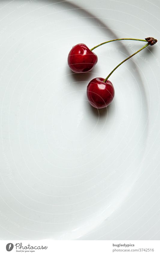 Two cherries on a white plate Cherry sour cherries Plate sweet cherry fruit Fresh Sweet Mature Summer Food Minimalistic Glittering Harvest Red Juicy