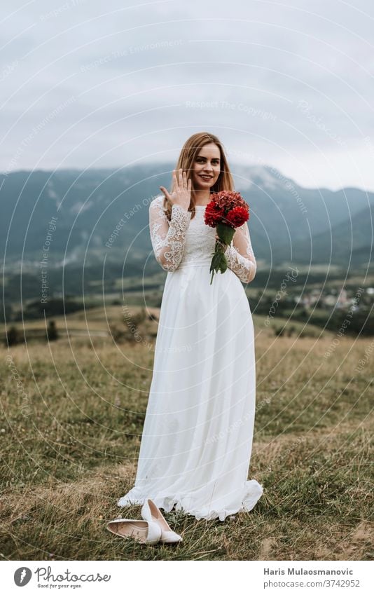 Beautiful bride in wedding dress holding ring on the hand, outdoors in nature adult attractive background beautiful beauty bouquet bridal brunette caucasian