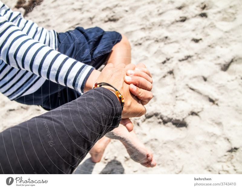 hand in hand in the sand Amber Beach Love Hold hands Family & Relations Protection Hand Infancy Parents Child Son Mother Safety Safety (feeling of)