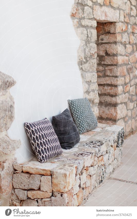 Geometric pillows near a wall in a garden Table chairs villa yard window white rustc black Patio House Architecture Scene Travel Outdoor italy street cafe empty