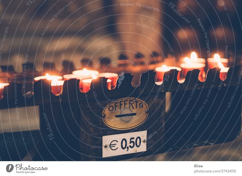 Burning sacrificial candles, which are lit in an Italian church for a donation of 50 cents Sacrificial candle Donation Costs 50cent Money commemoration