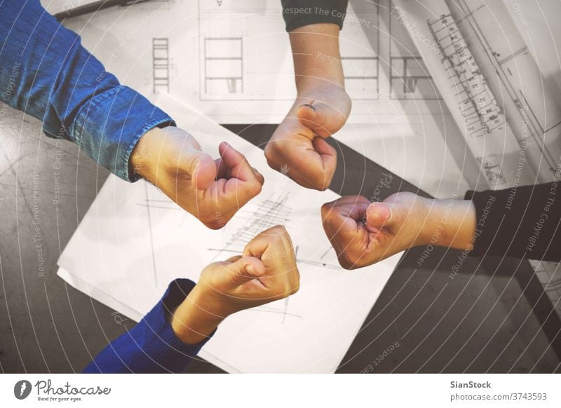 Successful young business team giving thumbs up to show their success and motivation, close up view of their raised hands people joining like teamwork group
