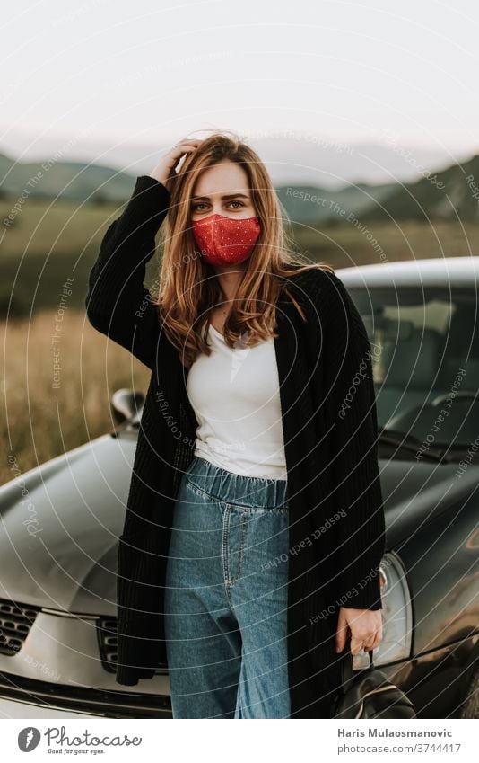 Young woman with mask in solo adventures in nature attractive auto beautiful car caucasian drive driver face mask fashionable female happiness happy journey