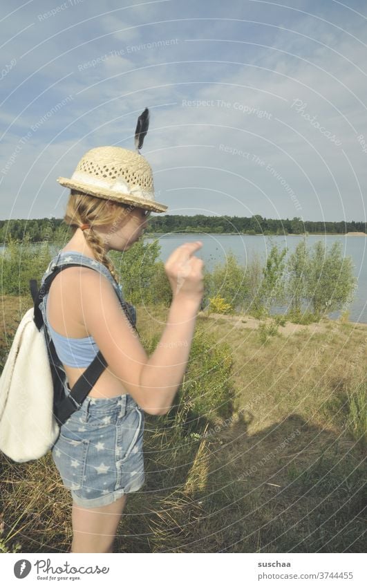 girl with feather on her hat at a lake Lake Germany Nature Trip Hiking Summer Straw hat Feather Backpack Adventure Vacation & Travel Freedom Landscape