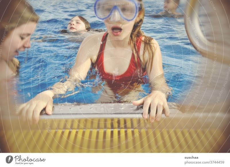 child with diving goggles at the edge of a swimming pool Child girl Pool border Swimming pool Wet Water be afloat swimming lessons Dive Swimming & Bathing