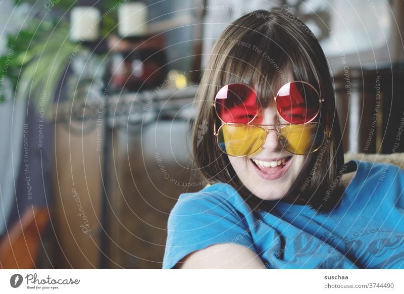 laughing teenager with 2 coloured sunglasses Youth (Young adults) Funny Laughter Joy fun Red Yellow Face Happiness luck youthful girl smile Puberty funny
