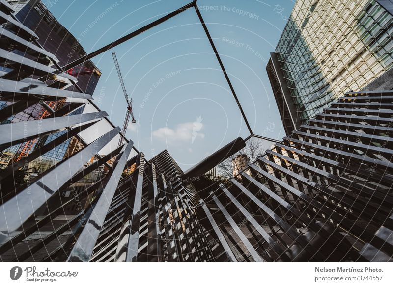 Shot of a Geometric Architecture. View of a square, the sky and buildings. design geometric structure light steel blue architecture modern street staircase
