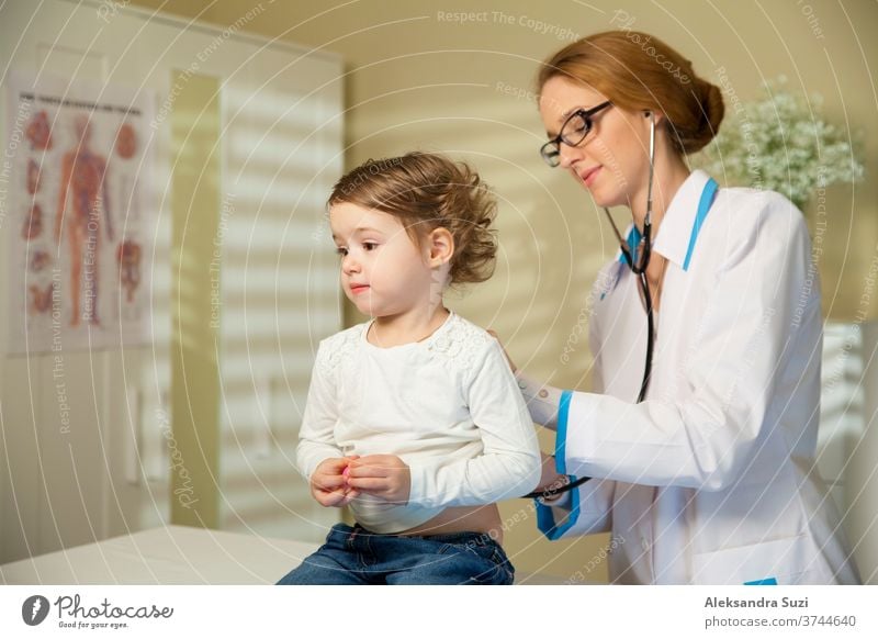 Cute little girl and doctor. Pediatrician woman examining cute little girl with stethoscope. Kid looks healthy and happy pediatrician baby toddler examination