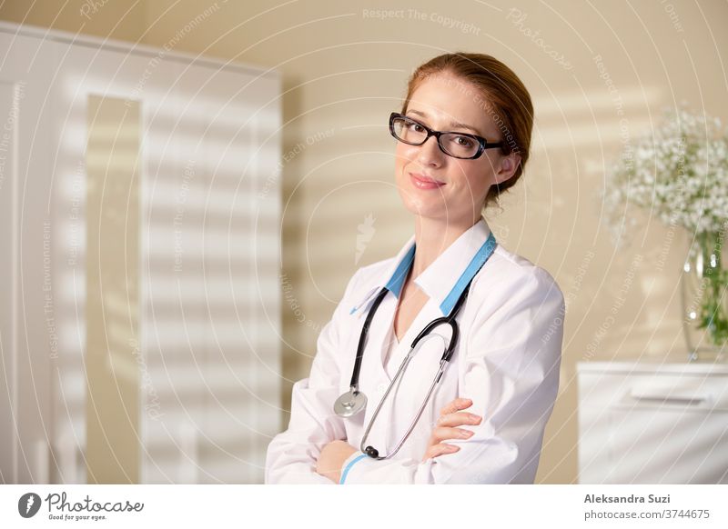 Young beautiful doctor in classes and white robe with stethoscope holding big book care career caucasian clinic coat competent confident connection consulting