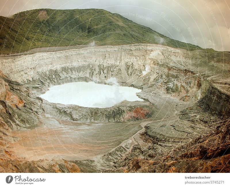 The crater of the Poas volcano in Costa Rica. You can see the acid lake and the barren mountain landscape with the great colors Poison Acid Volcano Mountain