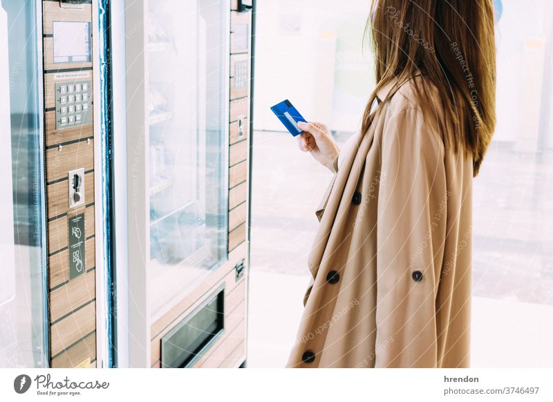 woman uses her credit card to pay at the vending machine tourist traveling voyage economy virus coronavirus epidemic pandemic mask protection outbreak infection