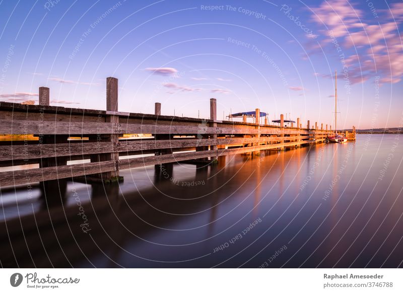 Jetty of lake Altmühlsee during sunset on summer evening water sailing boat altmühlsee jetty long exposure bridge landing stage abutment architecture beautiful