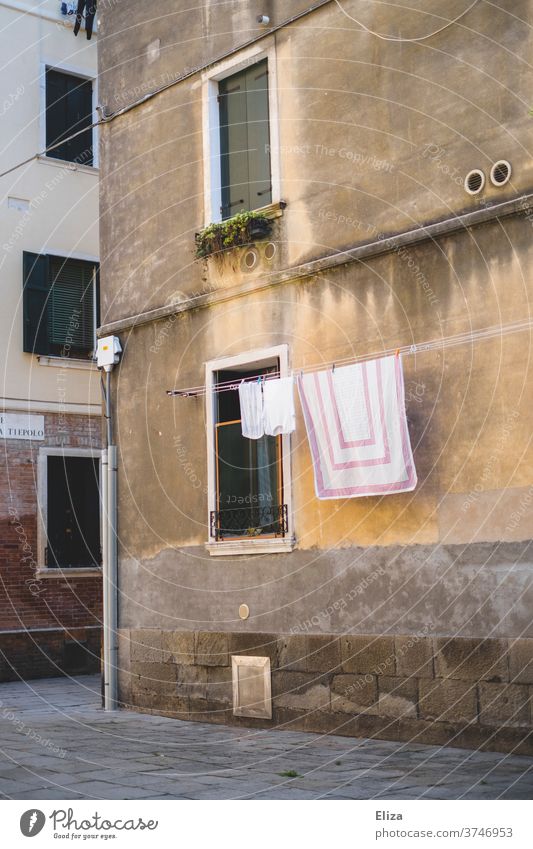 Freshly laundered laundry hanging on a clothesline in a quiet alley in Italy Clothesline Laundry Alley out Old town Facade Living or residing Dry