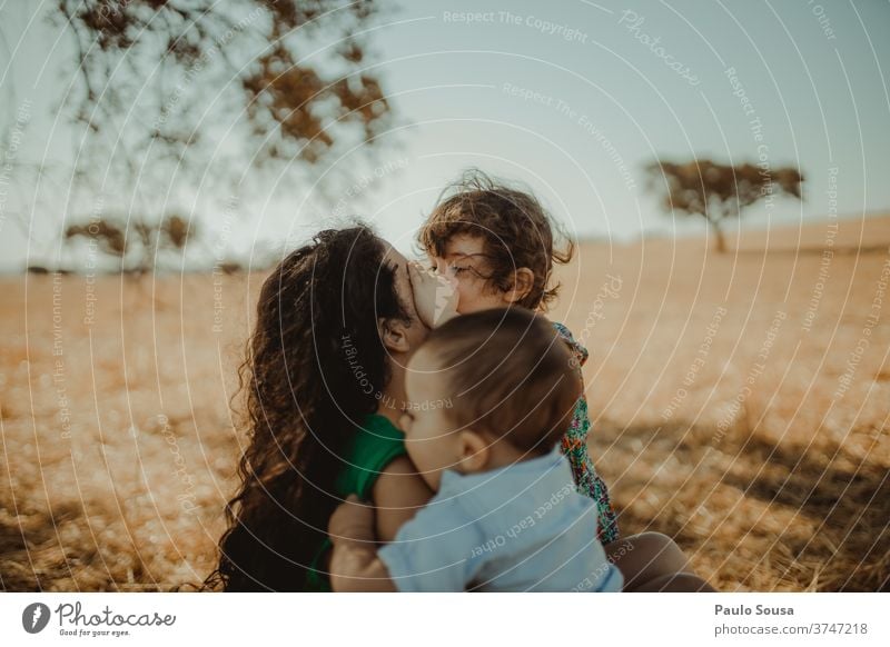 Mother with two childs in the fields motherhood people Child childhood care Family & Relations Love Parents Happiness Lifestyle Infancy Woman Hold Smiling