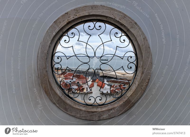 Through the round window you can see the roofs of Lisbon and the Tejo opening Window Pattern Vantage point ship outlook Old town height Bairro Alto Upper Town