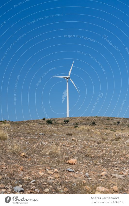 Mountainous landscape with wind energy mills mixing rural life with renewable technologies view mist ecology generation aerial power wind turbines