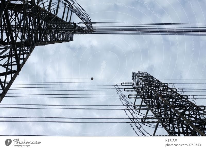 Close up view , high voltage power lines station. High voltage electric transmission pylon silhouetted tower. architecture background cable construction danger