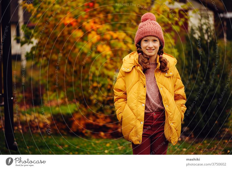 cute kid girl walking in autumn garden or park, wearing warm stylish clothes child season fun nature outdoor joy happy childhood gardening leaf outside playing