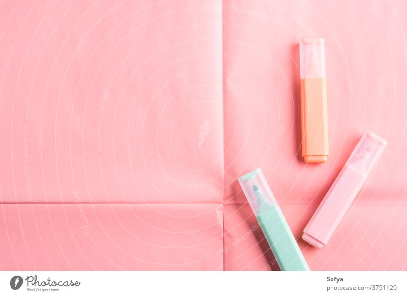 Pastel markers on coral pink background highlighter pastel color geometrical stationery write school study education university shop store office supply coloful