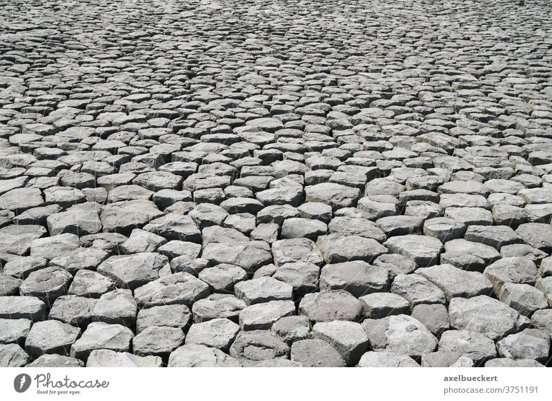 cobblestone background with uneven natural stone - a Royalty Free