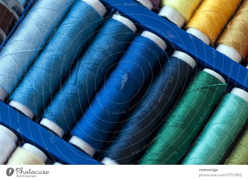 Close-up on colored sewing threads on spools - a Royalty Free Stock Photo  from Photocase