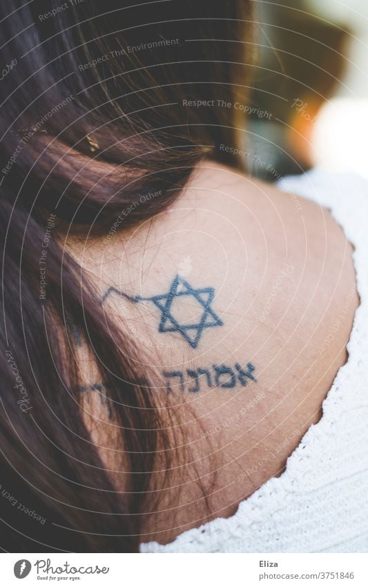 Woman with Star of David and Hebrew characters tattoo on back Tattoo Judaism Jewish Belief Religion and faith religion Jewess Back symbol writing Characters
