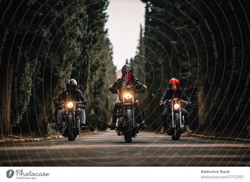 Bikers on motorcycles driving on country road biker motorbike ride drive group speed power fast travel freedom route transport adventure vehicle journey motion