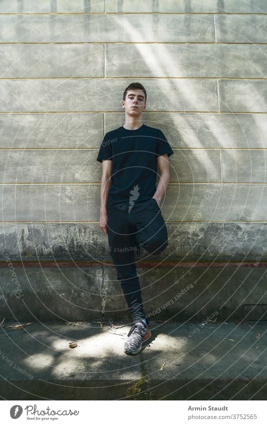 A Tall, Thin Man Brunette Posing By The Grunge Wall. Men's Beauty, Fashion.  Stock Photo, Picture and Royalty Free Image. Image 49798833.