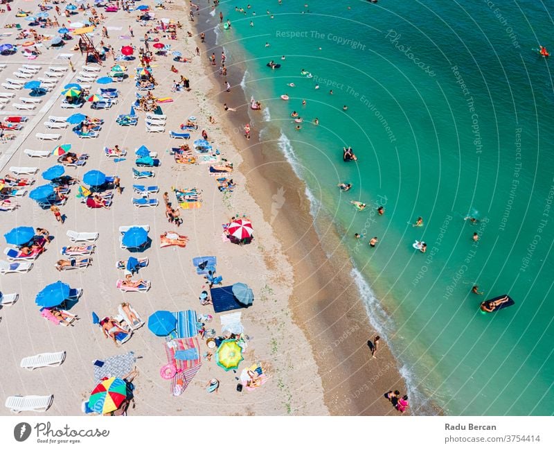 Aerial View Of People And Colorful Umbrellas On Ocean Seaside Beach In Summer beach aerial view sand background water sea vacation blue travel people